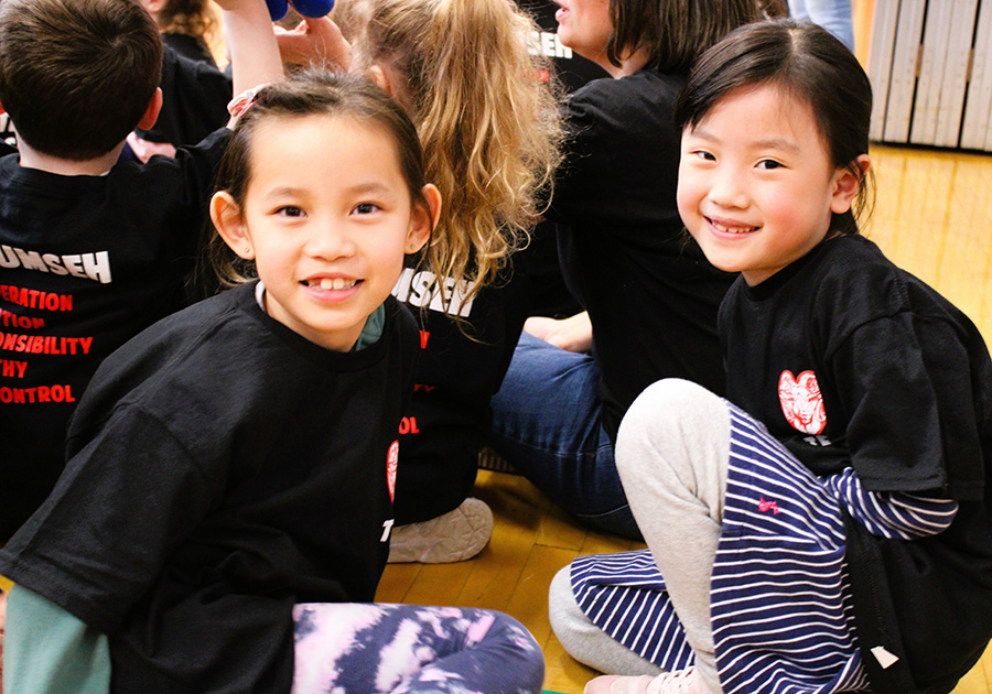 Image of two Tecumseh students posing for the camera during assembly.