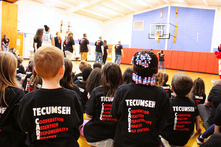 Image of students wearing Tecumseh Cares shirts during March Madness Assembly.