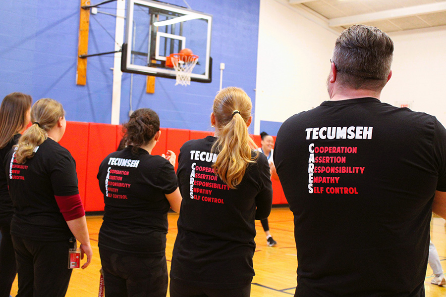 Image of staff wearing Tecumseh Cares shirts during March Madness Assembly.