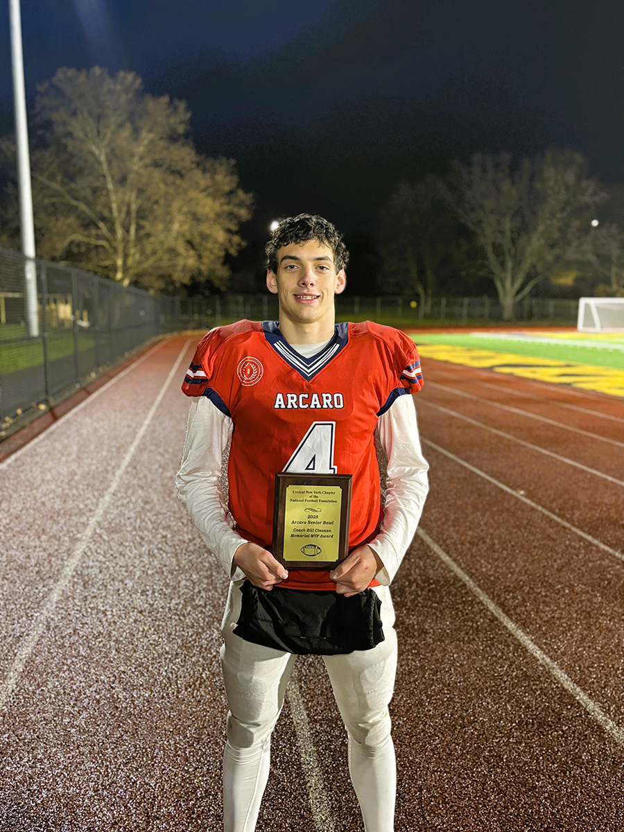 Anthony Guidone poses for photo with plaque.