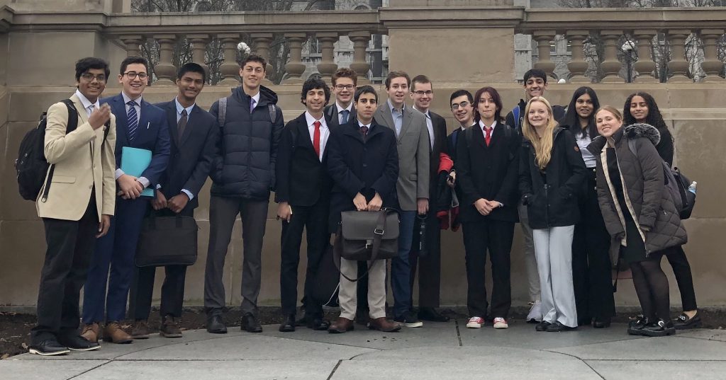 Group of students standing together outside.