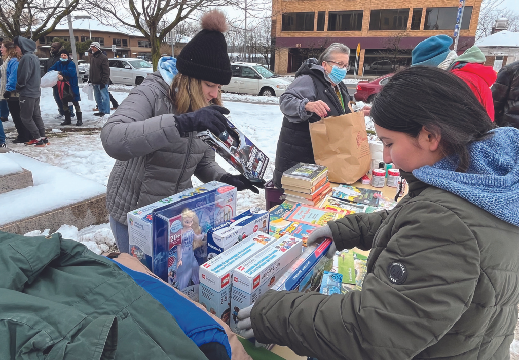 Morgan Moracco (left) and Cielo Martinez (right) volunteer with We Rise Above the Streets. 