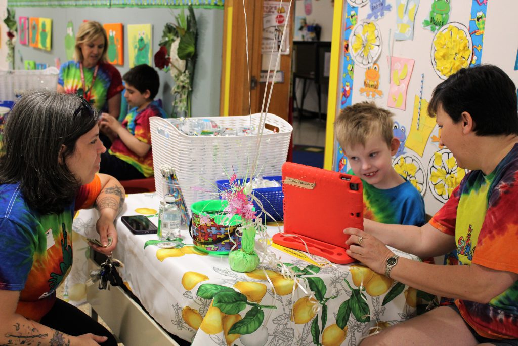 Image of student, parent, and Learning Pad staff member at fundraiser.