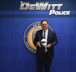 Photo of J-D Middle School Principal Andy Eldridge holding a police award.