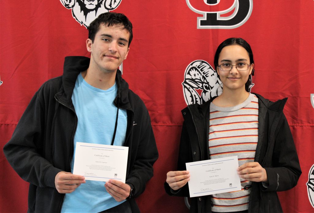 Photo of Aiden Caporaso and Sehej Bajwa holding Certificate of Merit awards.