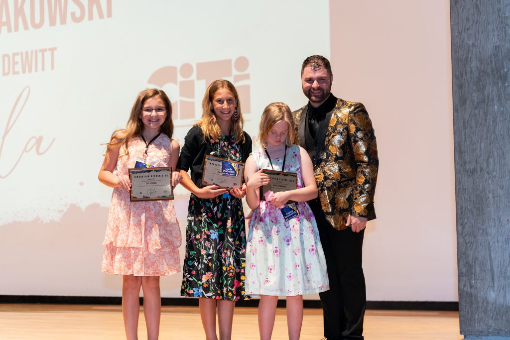 Photo of Jamesville DeWitt Middle School students Kate Schlegel, Giada Podbelski, and Hayley Synakowski being recognized during the Gala for the Arts at the Everson Museum in downtown Syracuse on June 21.