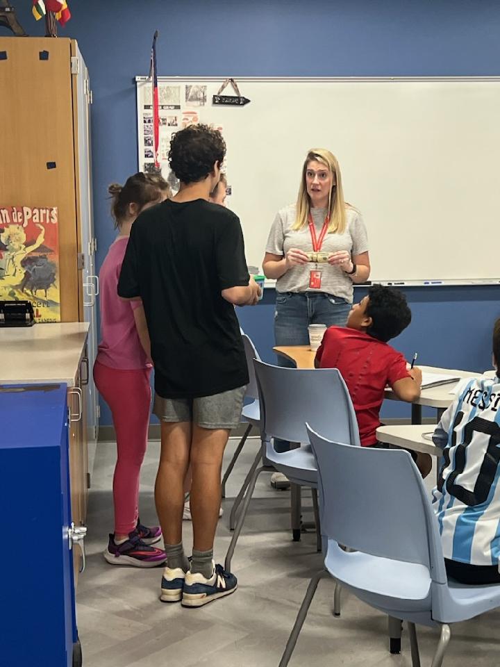 Image of students delivering drinks to teachers.