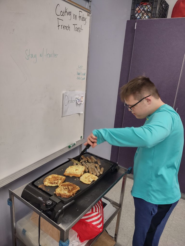 Image of student cooking french toast.