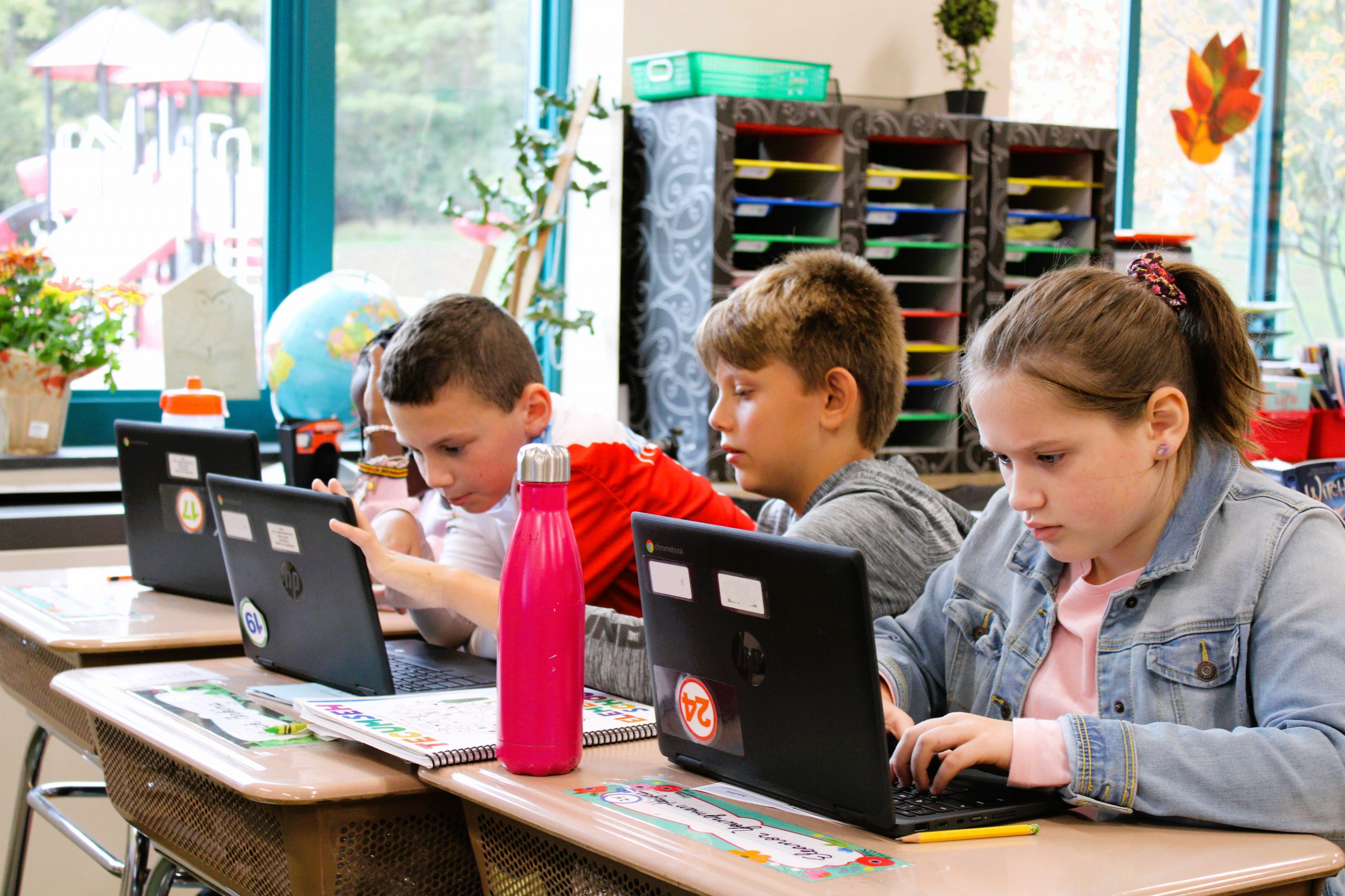 Image of several students working on chromebooks.