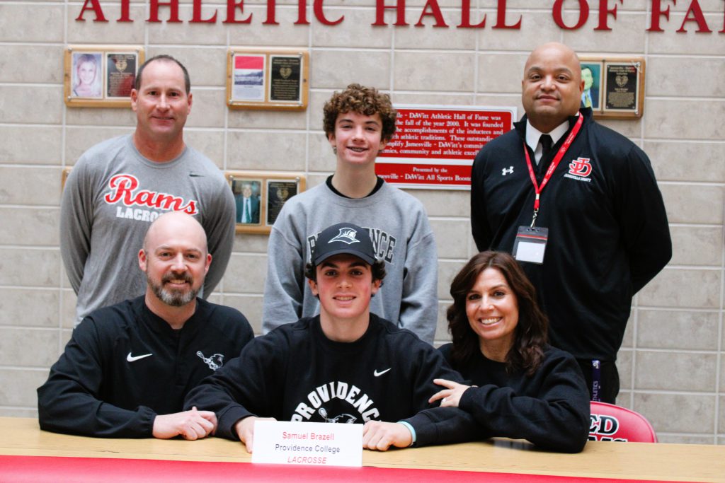 Image of Sam Brazell signing letter of intent for Providence University, Lacrosse.