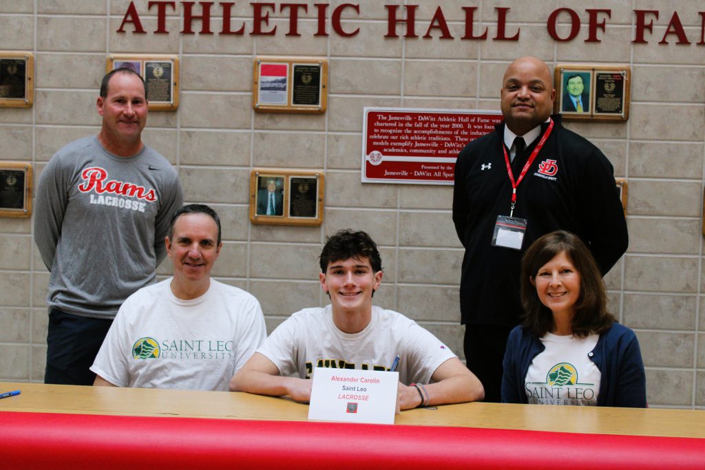 Image of Alex Carolin signing letter of intent for Saint Leo University, Lacrosse.