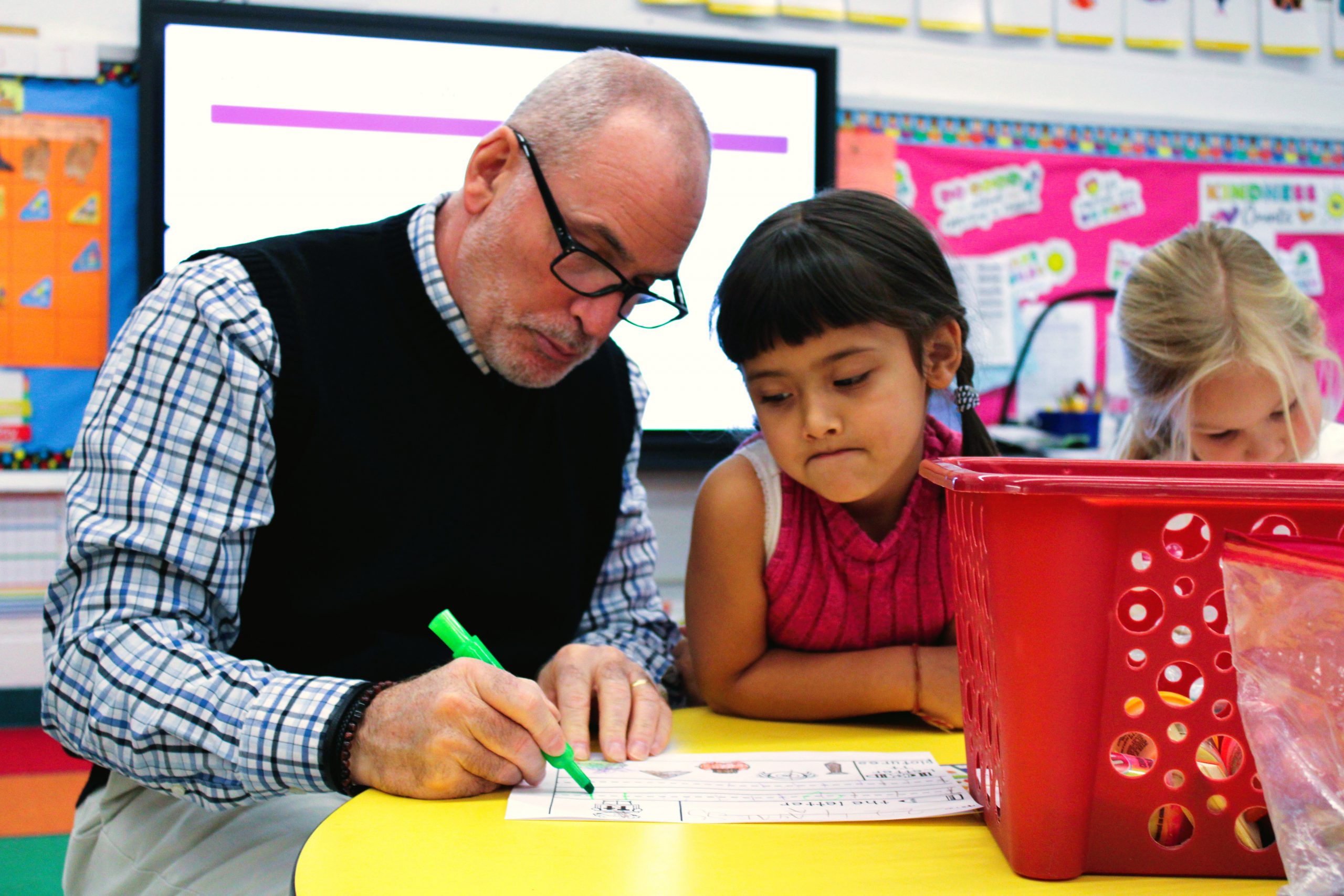 Image of teacher working with a student.