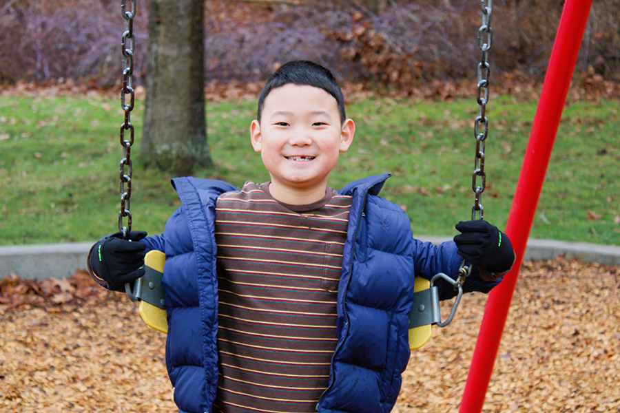 Image of smiling student on swing.