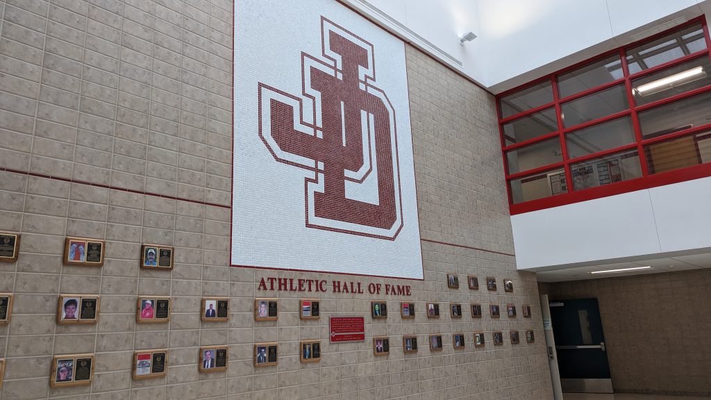 Image of Athletic Hall of Fame plague and wall of photos.