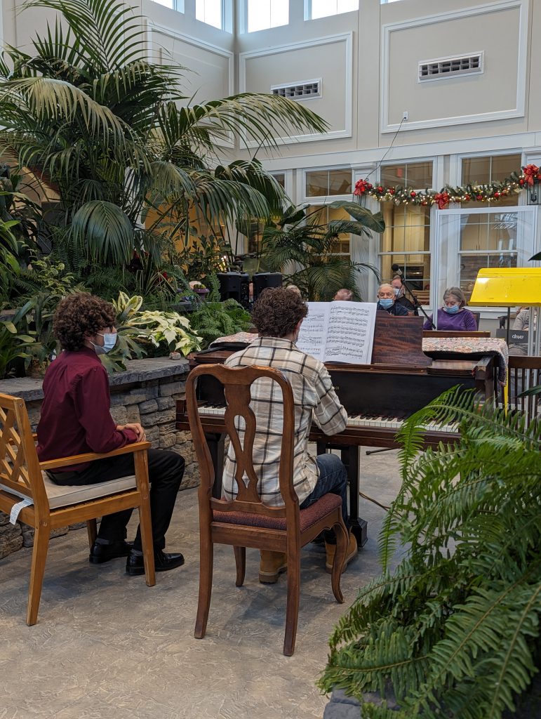 Image of two students performing for Mending Melodies.