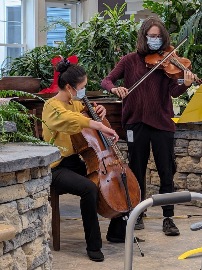 Image of two students performing for Mending Melodies.