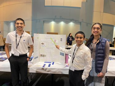 Image of Jamesville-DeWitt Middle School seventh-graders Om Vaidya, Simran Sanders, and Akul Pawar at the CNY Science & Engineering Fair.