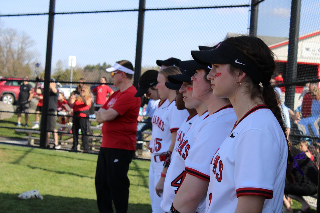 Image of J-D Varsity Softball players watching the opening ceremony.