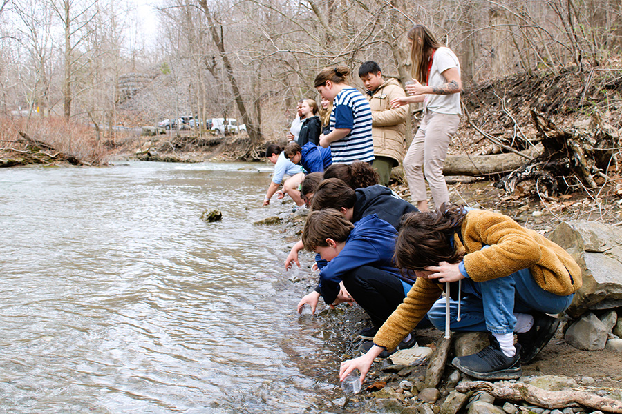 Students release Atlantic Salmon raised in class during field trip.