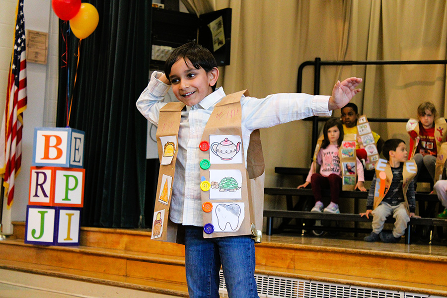 Tecumseh Kindergarten student poses in ABC fashion show wearing decorated letter vest.