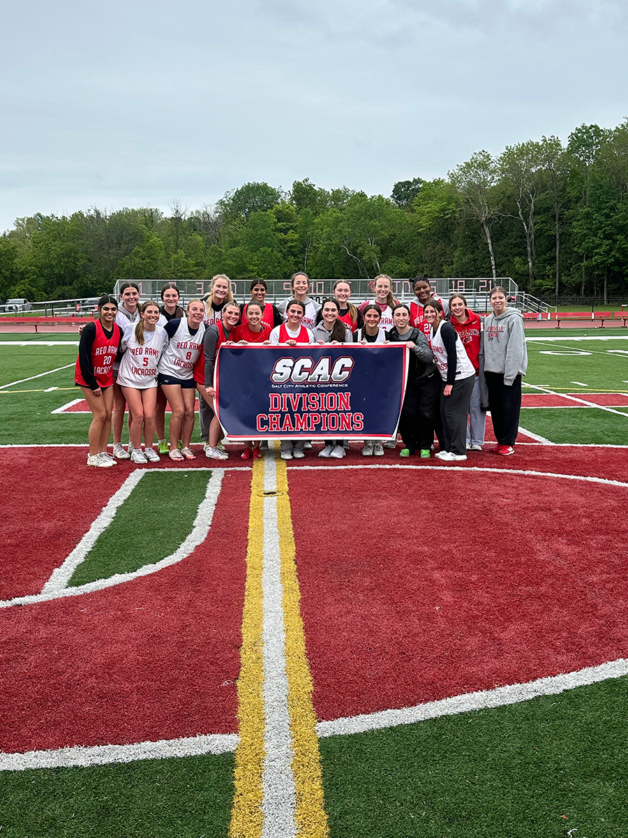 2025 girls lacrosse team pose with SCAC League Champs banner.