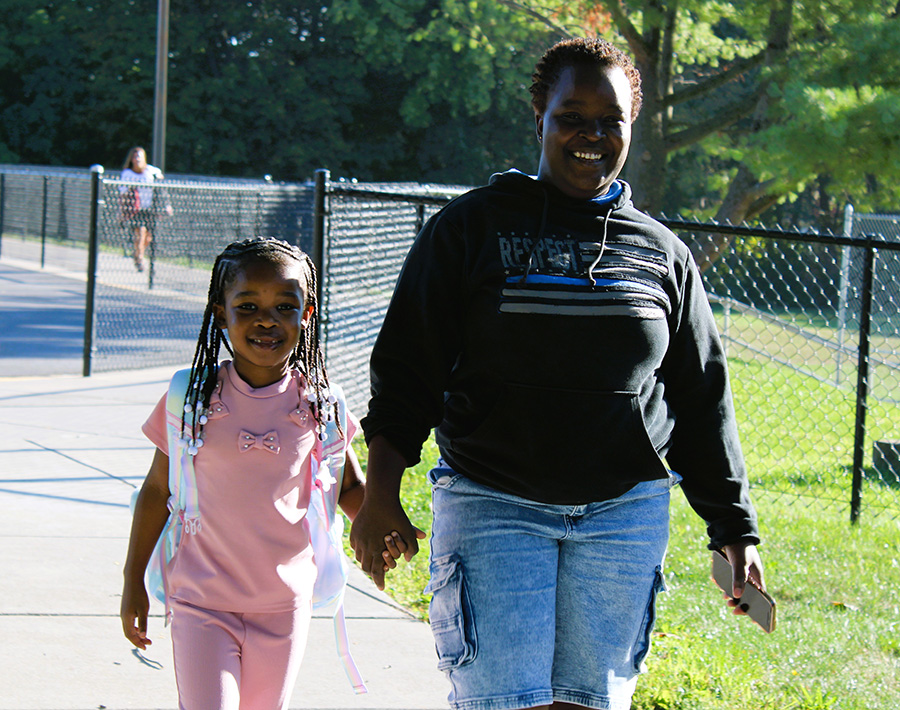 Parent walks student into Moses DeWitt on first day of school.