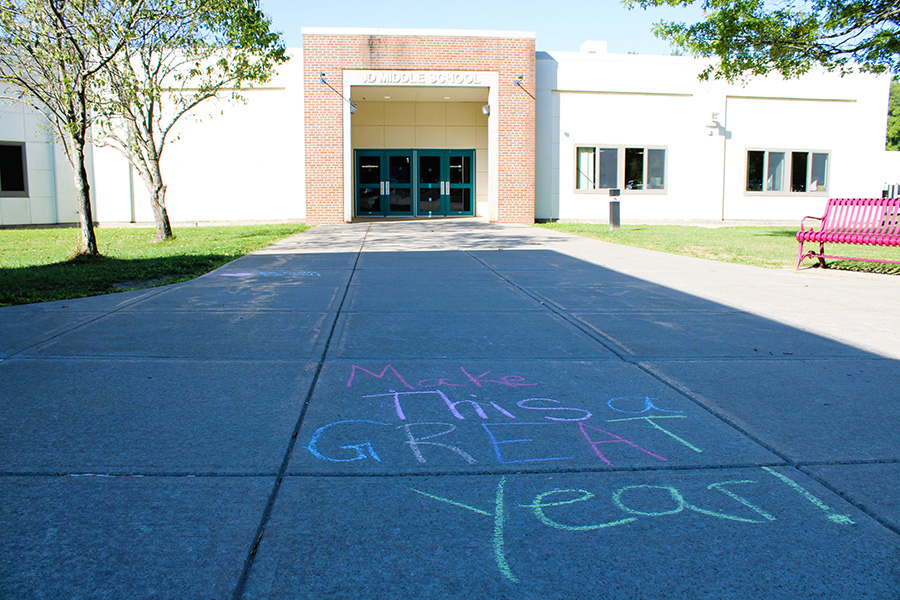 Inspirational message in chalk in front of school.