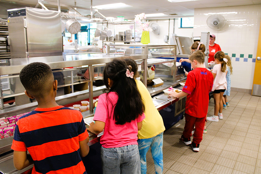 Students stand in line for lunch.