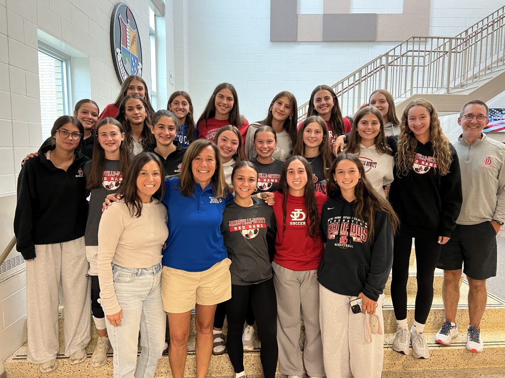 The J-D Varsity Girls Soccer Team poses for group photo with Marcy Baker.