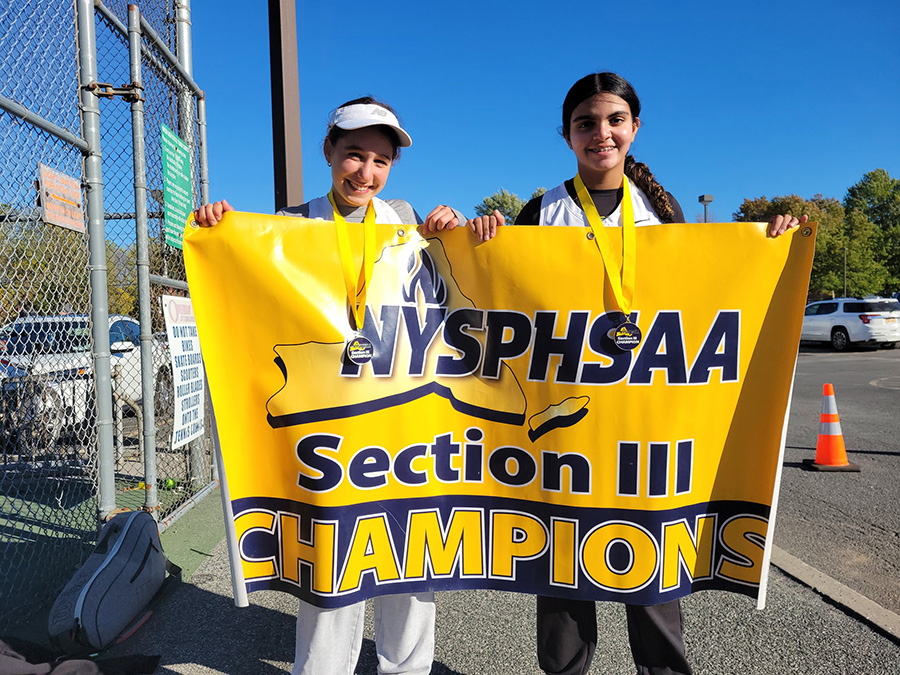 Two students hold up section championship banner.