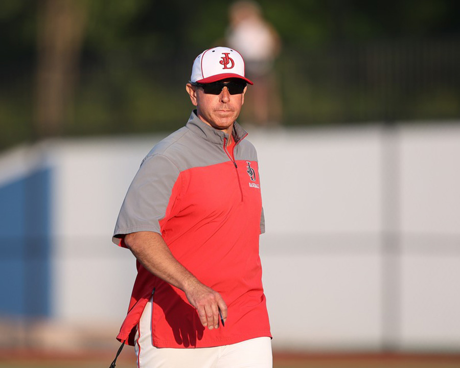 Coach Ryan Dera walks on field.
