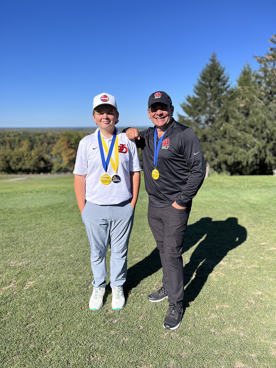 Brayden Thomas poses with coach.