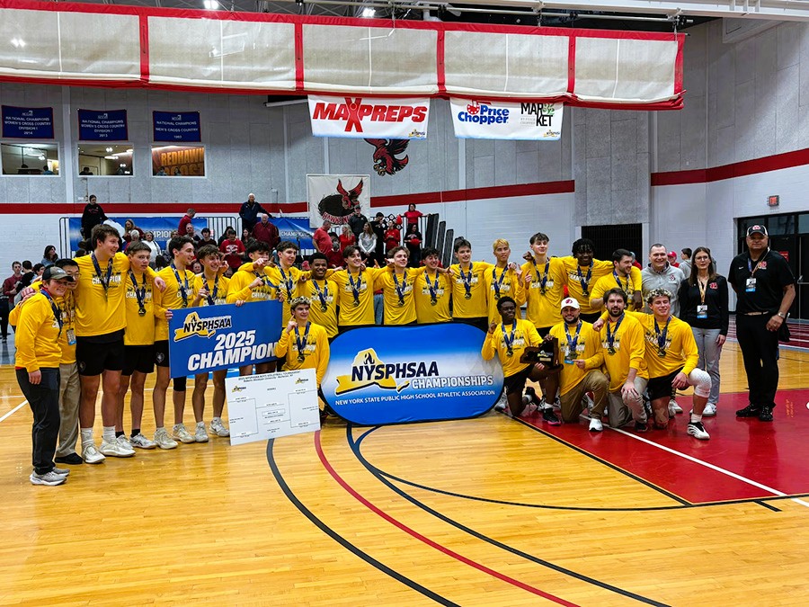 J-D boys volleyball team poses for group photo with state championship banner.