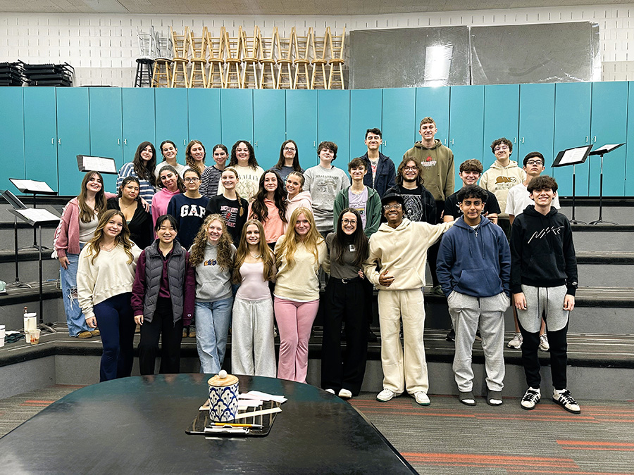 In Achord group members stand for group photo in chorus room.