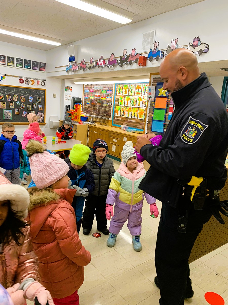 SPO helps preK students gear up in classroom for playing in the snow during recess. 