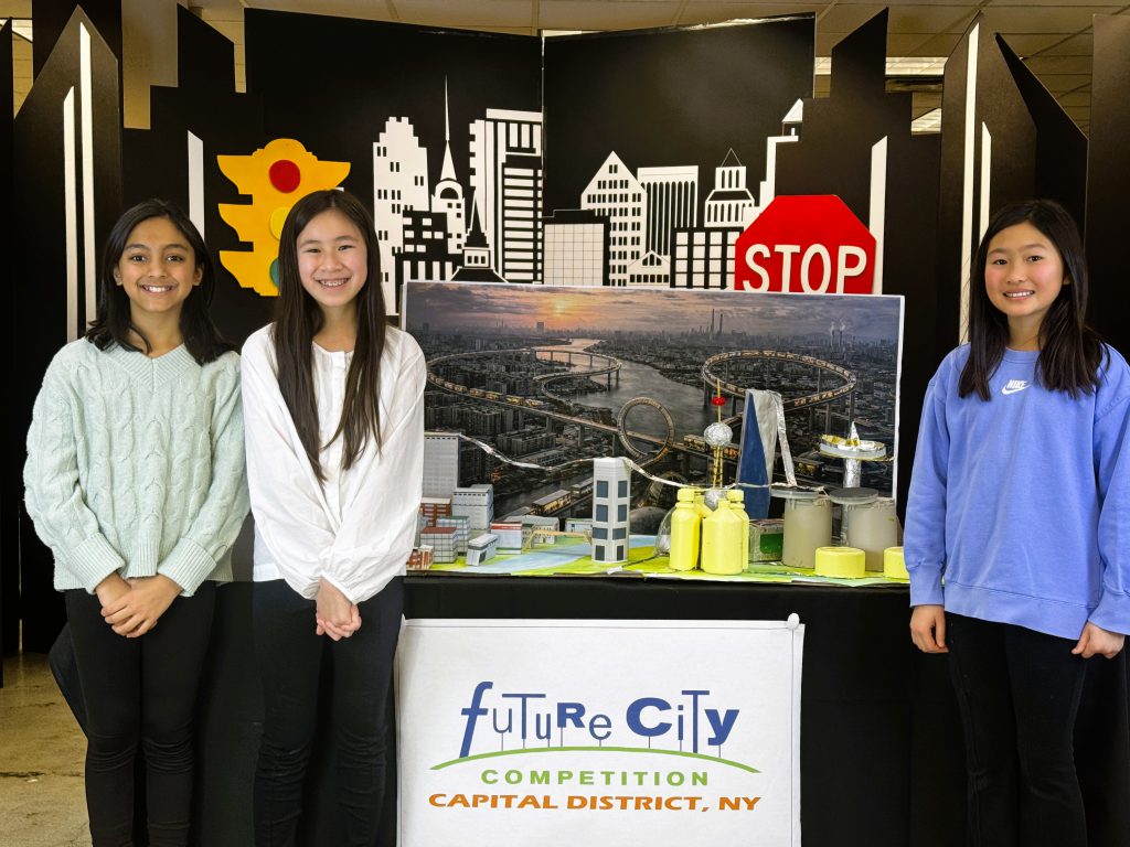 Siobhan Yung, Olivia Zhang, and Pramiti Adhikari pose for photo with STEM project.