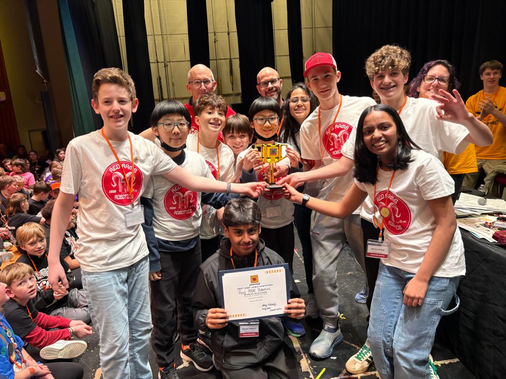 Red Ram Robotics team poses for group photo with trophy.