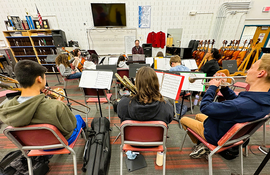 Students play instruments in Orchestra room.