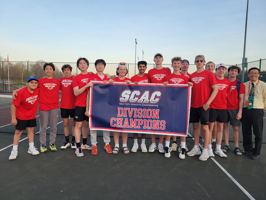 Boys Tennis team poses for group photo with banner.