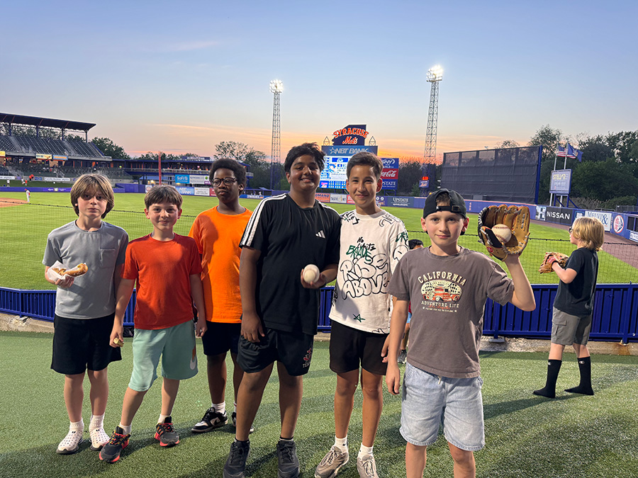 Students pose for photo at Syracuse Mets game.