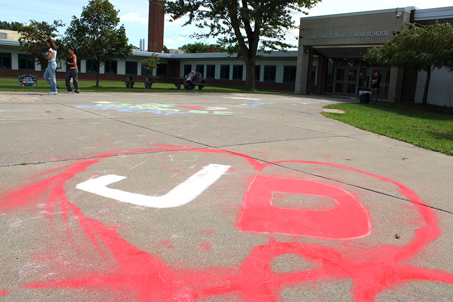 J-D spelled in white and red chalk in front of the high school.