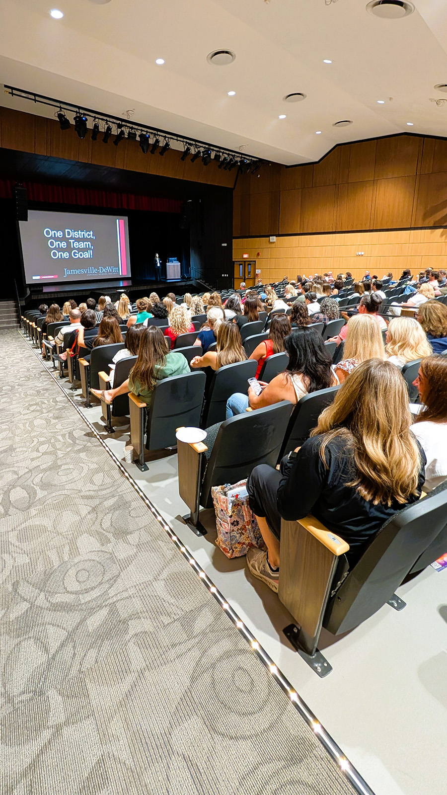 Staff fill auditorium seats.