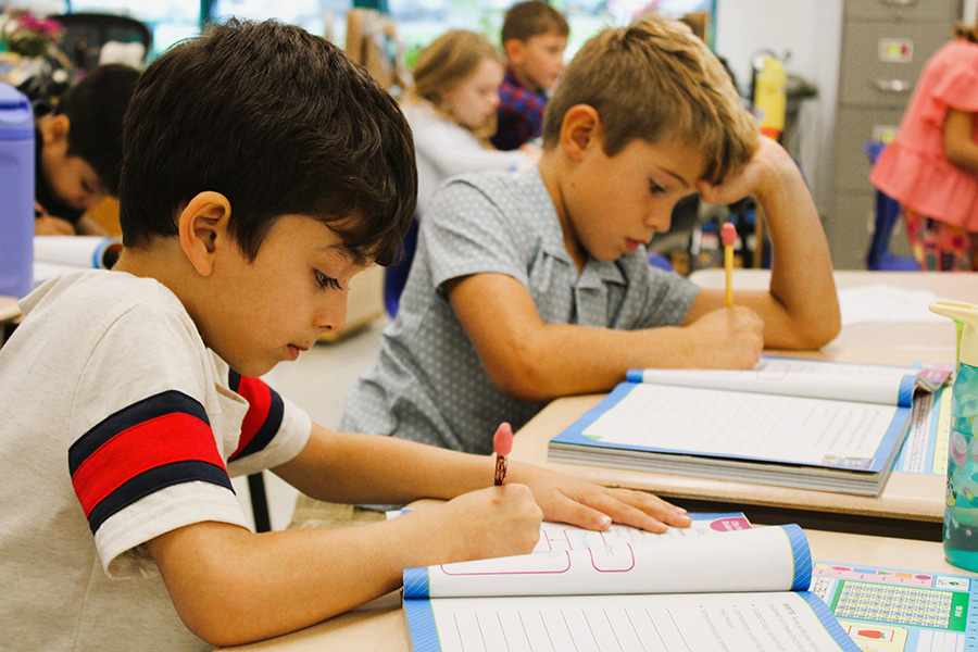 Students work at desks.